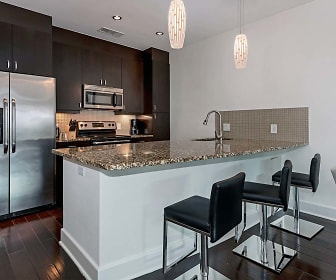 kitchen featuring a breakfast bar, stainless steel appliances, range oven, granite-like countertops, dark brown cabinetry, dark parquet floors, and pendant lighting, 1045 on the Park Apartment Homes