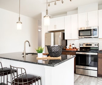 kitchen featuring stainless steel appliances, electric range oven, pendant lighting, white cabinets, light hardwood floors, and dark stone countertops, Dartmoor Place