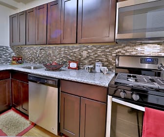 kitchen featuring gas range oven, stainless steel appliances, stone countertops, dark brown cabinets, and light parquet floors, Westerlee Apartment Homes