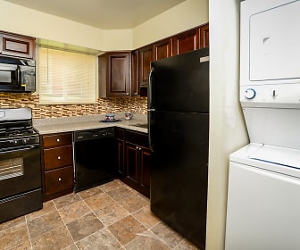washroom featuring tile floors, refrigerator, stainless steel microwave, washer / dryer, dishwasher, and gas range oven, Glen Ridge Apartment Homes