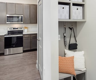 mudroom featuring hardwood flooring, stainless steel microwave, and electric range oven, Metro University Center