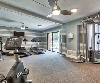 gym featuring a ceiling fan, carpet, wood beam ceiling, natural light, and TV, Parkway Apartments