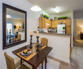 kitchen featuring lofted ceiling, refrigerator, extractor fan, pendant lighting, light flooring, light countertops, and brown cabinetry, Crescent at Wolfchase