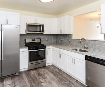 kitchen featuring gas range oven, stainless steel appliances, white cabinets, light granite-like countertops, and light parquet floors, The Mews at Annandale Townhomes