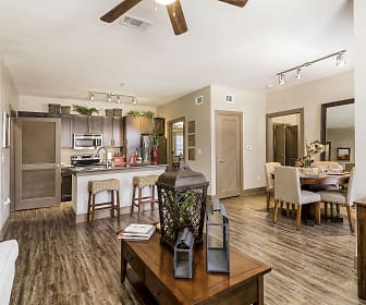 hardwood floored living room featuring a ceiling fan, a breakfast bar, range oven, and microwave, Sedona Ranch
