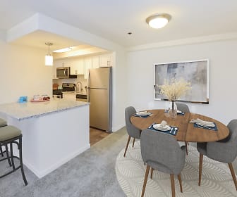 dining area with a breakfast bar, stainless steel refrigerator, range oven, and microwave, Strafford Station Apartment Homes