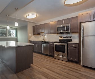 kitchen featuring a center island, natural light, electric range oven, stainless steel appliances, dark brown cabinets, dark parquet floors, light countertops, and pendant lighting, Towers At Wyncote