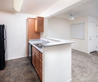 kitchen with carpet, a ceiling fan, refrigerator, dishwasher, range oven, light flooring, and brown cabinets, Antelope Ridge