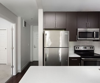 kitchen featuring electric range oven, stainless steel appliances, dark brown cabinetry, light countertops, and dark hardwood floors, James and Harrison Court Apartments