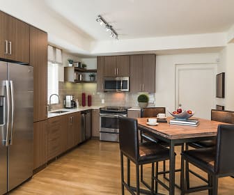 kitchen with stainless steel appliances, range oven, dark brown cabinetry, light countertops, and light parquet floors, 8000 Uptown