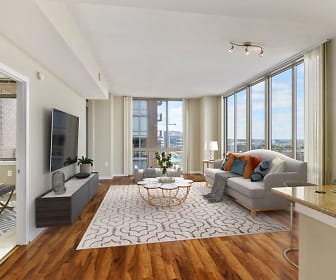 living room with hardwood flooring, a healthy amount of sunlight, and TV, The Cosmopolitan at Reston Town Center