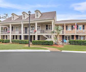 view of building exterior with a yard, Manor House Apts