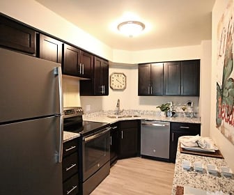 kitchen featuring refrigerator, electric range oven, stainless steel dishwasher, light hardwood floors, dark brown cabinets, and light stone countertops, Hamilton House