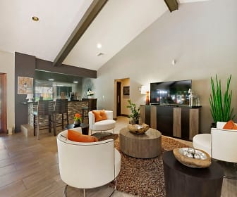 building lobby featuring vaulted ceiling, natural light, hardwood floors, and TV, Lakepointe at Jacaranda Apartments