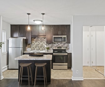kitchen with stainless steel appliances, electric range oven, granite-like countertops, pendant lighting, light parquet floors, and dark brown cabinets, Minikahda Court Apartments