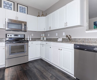 kitchen featuring stainless steel appliances, range oven, dark hardwood floors, stone countertops, and white cabinets, The Apartments at Aberdeen Station