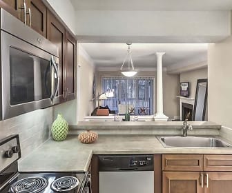 kitchen featuring natural light, stainless steel microwave, dishwasher, dark brown cabinets, light countertops, and pendant lighting, Camden Fairview