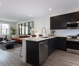 kitchen featuring plenty of natural light, stainless steel appliances, range oven, dark brown cabinetry, light countertops, and light parquet floors, Revela