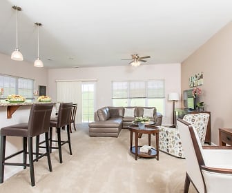 carpeted dining area featuring a breakfast bar, a ceiling fan, and TV, Preserve at Autumn Ridge