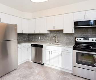 kitchen with electric range oven, stainless steel appliances, white cabinets, light countertops, and light tile floors, Brockport Crossings