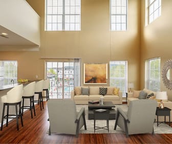 hardwood floored living room featuring a healthy amount of sunlight, a high ceiling, a breakfast bar, and refrigerator, The Waterfront