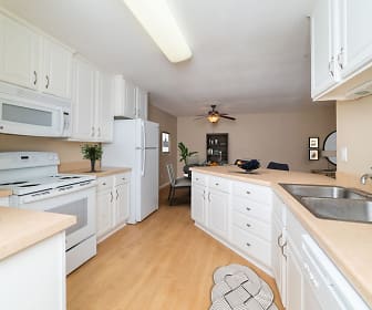 kitchen with a ceiling fan, refrigerator, dishwasher, electric range oven, microwave, white cabinetry, light parquet floors, and light countertops, Victoria Place