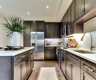 kitchen with stainless steel refrigerator, microwave, dishwasher, range oven, light hardwood floors, dark brown cabinets, and light countertops, Preston Hollow Village Apartments