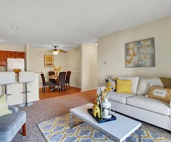 living room featuring hardwood floors, a ceiling fan, a kitchen breakfast bar, and refrigerator, Breezewood
