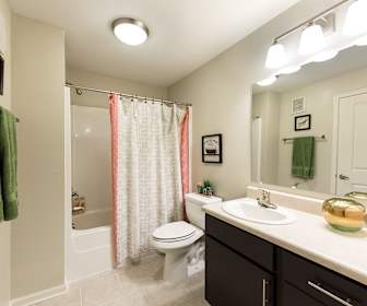 full bathroom featuring tile floors, mirror, toilet, shower / bathing tub combination, vanity, and shower curtain, 3 Springs Apartments