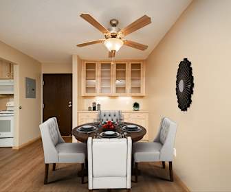 dining room with a ceiling fan, hardwood flooring, electric range oven, and microwave, Park Villa Apartments