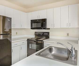 kitchen featuring refrigerator, electric range oven, microwave, white cabinets, and light countertops, Bigelow Commons