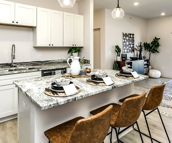 kitchen featuring natural light, granite-like countertops, light hardwood flooring, pendant lighting, and white cabinetry, Edge 204