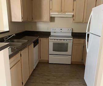 kitchen with electric range oven, refrigerator, dishwasher, fume extractor, dark hardwood floors, dark granite-like countertops, and light brown cabinetry, Copperfield Apartments