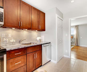 kitchen featuring stainless steel appliances, gas range oven, granite-like countertops, light tile flooring, and dark brown cabinets, Hutton Lafayette Apartments