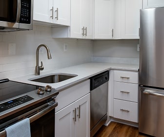 kitchen with stainless steel appliances, electric range oven, white cabinetry, dark parquet floors, and light countertops, Latrobe Apartments