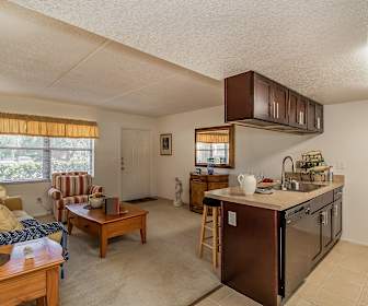 kitchen featuring a healthy amount of sunlight, dishwasher, light floors, and dark brown cabinetry, Melrose On The Bay