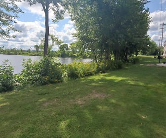 yard featuring a water view and an expansive lawn, Lakeside Manor