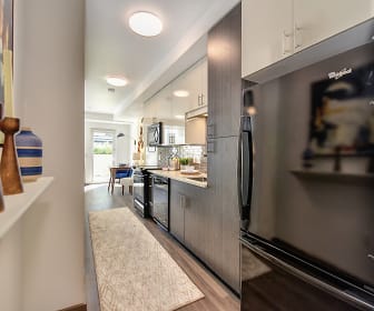 kitchen featuring refrigerator, dishwasher, microwave, light countertops, light hardwood floors, and white cabinetry, Rivet Apartments