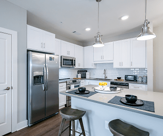 kitchen featuring stainless steel appliances, range oven, white cabinetry, pendant lighting, and dark hardwood floors, The Mark at Chatham Apartments