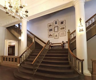 staircase featuring parquet floors and a notable chandelier, Old City Hall Apartments