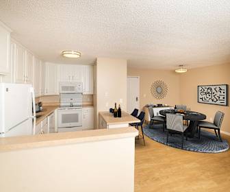 kitchen featuring refrigerator, range oven, microwave, white cabinets, light hardwood floors, light countertops, and pendant lighting, Riva Ridge