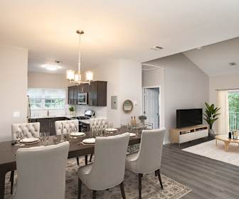 kitchen with plenty of natural light, gas range oven, microwave, pendant lighting, light countertops, dark brown cabinets, and light hardwood flooring, Fair Lawn Commons