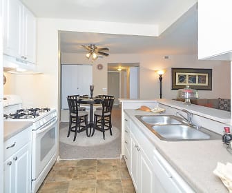 kitchen with a ceiling fan, refrigerator, gas range oven, dishwasher, fume extractor, light tile floors, white cabinets, and light countertops, Turtle Cove