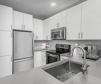 kitchen featuring electric range oven, stainless steel appliances, light countertops, and white cabinetry, Camden South End