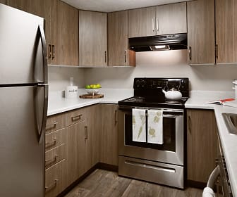 kitchen with refrigerator, ventilation hood, electric range oven, dark hardwood floors, brown cabinets, and light countertops, Clover Creek Apartments