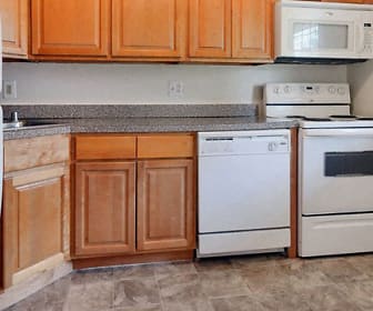 kitchen with refrigerator, electric range oven, dishwasher, microwave, stone countertops, dark tile floors, and brown cabinetry, Mapleton Square Apartment Homes