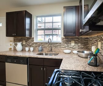 kitchen featuring natural light, dishwasher, light flooring, dark brown cabinetry, and light granite-like countertops, Lamberts Mill Village