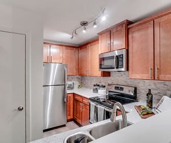 kitchen with electric range oven, stainless steel appliances, light floors, light countertops, and brown cabinetry, TGM Park Meadows