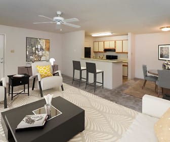 living room featuring a ceiling fan, a kitchen breakfast bar, and range oven, The Greens at Westgate Apartment Homes