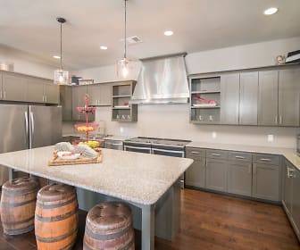 kitchen with stainless steel refrigerator, range oven, microwave, extractor fan, white cabinetry, dark parquet floors, pendant lighting, and light stone countertops, Carrington Oaks